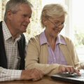 Image of two pensioners working at a compiuter screen