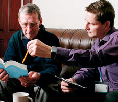 Two men discussing a form
