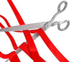 Scissors cutting red tape
