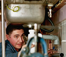 A man working on a sink