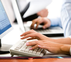 Hands typing at a keyboard