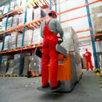 Man in warehouse moving stock