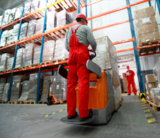 Man in warehouse moving stock