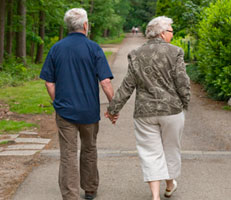 Two pensioners walking hand in hand
