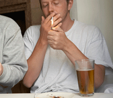 man smoking and drinking