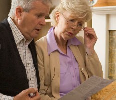 Retired couple reading pensions letter
