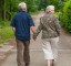 Two pensioners walking hand in hand