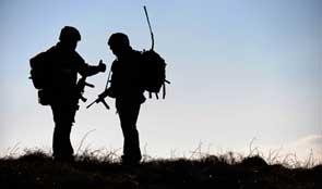 Silhouette of two soldiers