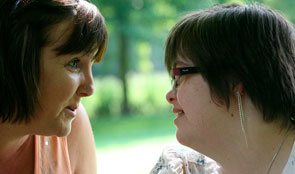A girl with Downs Syndrome in conversation