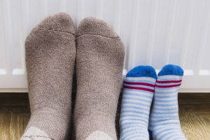 Stockinged feet against a radiator