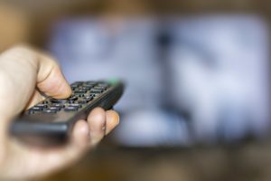 Hand holding a remote control