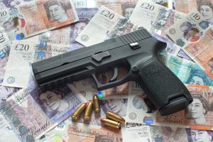 Gun on a pile of bank notes