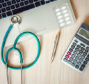 a stethoscope lying on a laptop