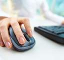 A hand on a computer mouse