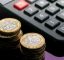 Calculator and stack of coins
