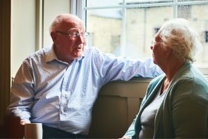 Two elderly people talking