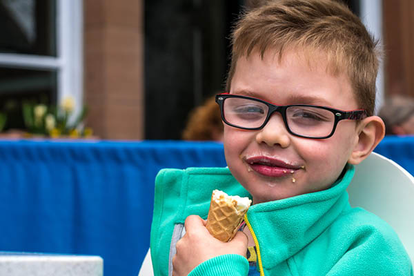 Young white boy eating an ice cream