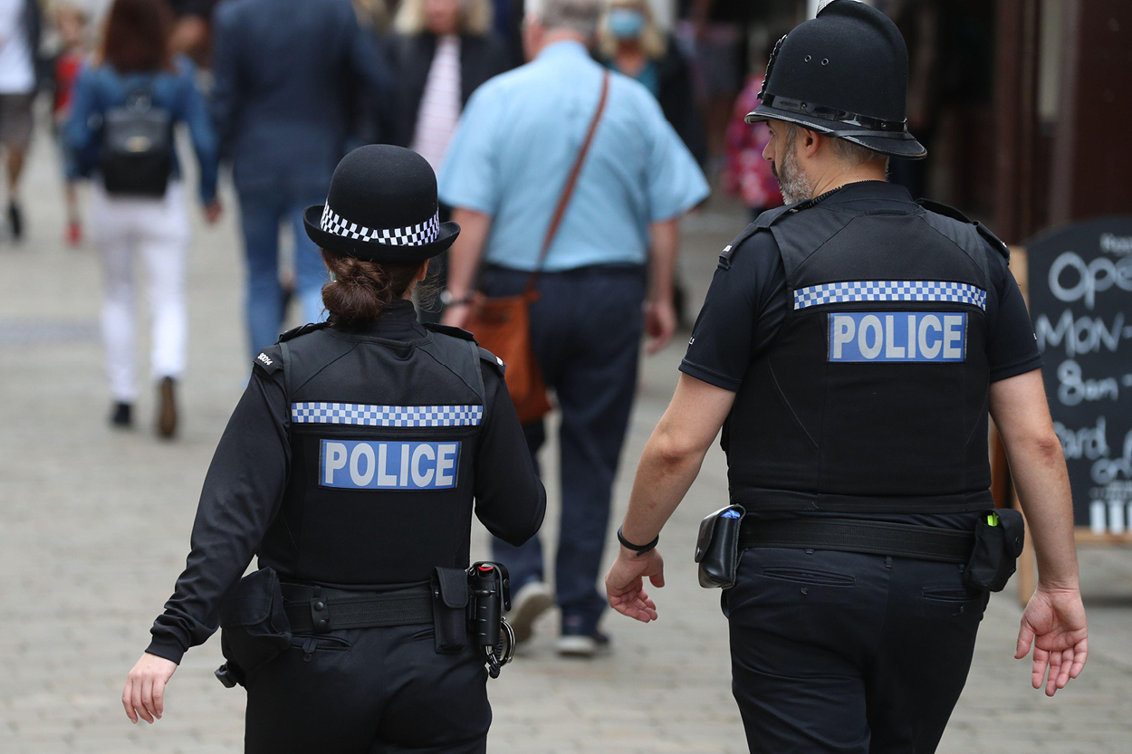 Female and male police officer walking down the street