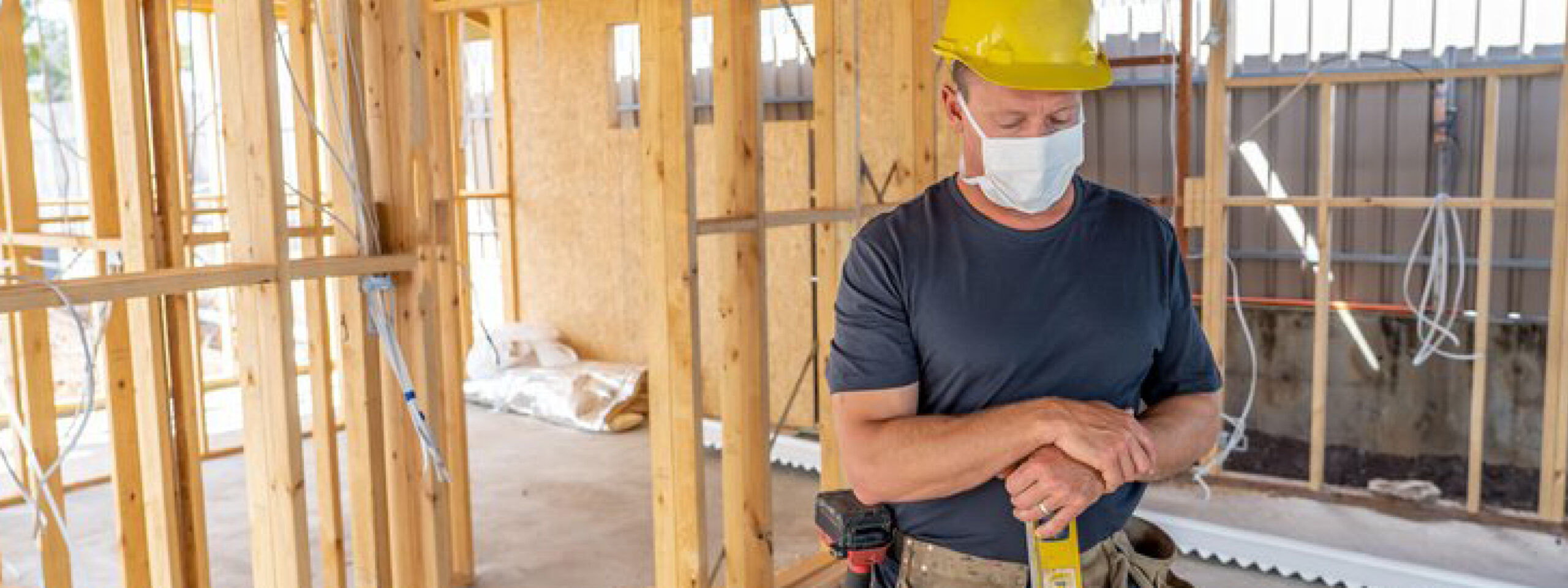 Carpenter wearing a hard hat on a building site