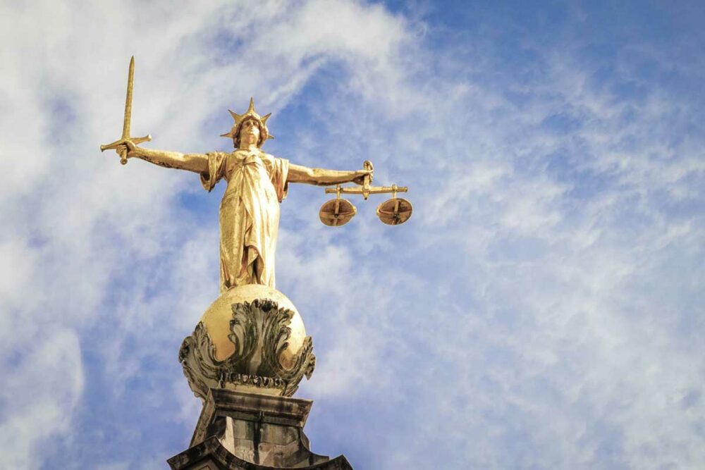 Gold statue on top of the Old Bailey