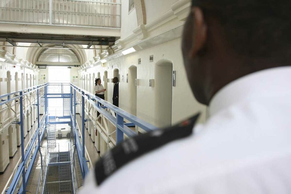 Prison wing viewed over the shoulder of a guard