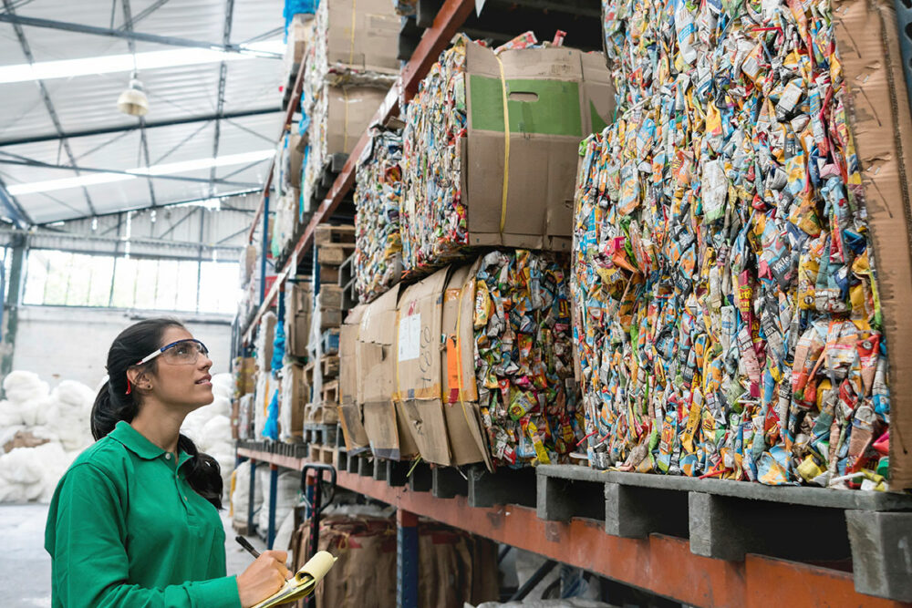 Woman documenting waste at a waste management and recycling centre