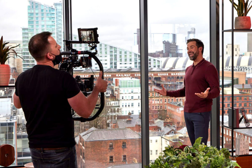 Cameraman filming a male TV presenter