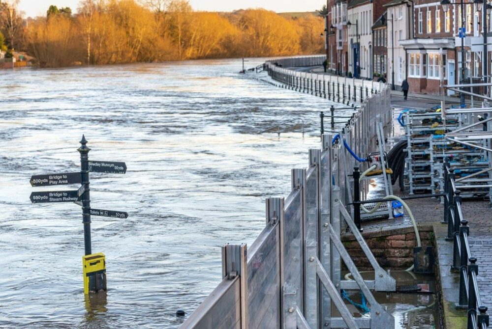 Flood defenses attempting to prevent high river flooding a town