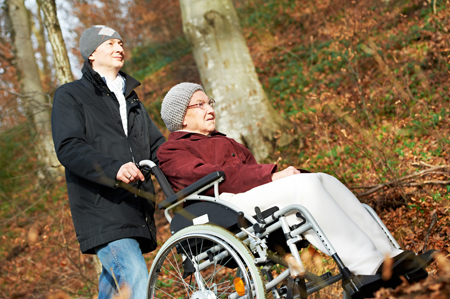 Photo of Man pushing woman in wheelchair